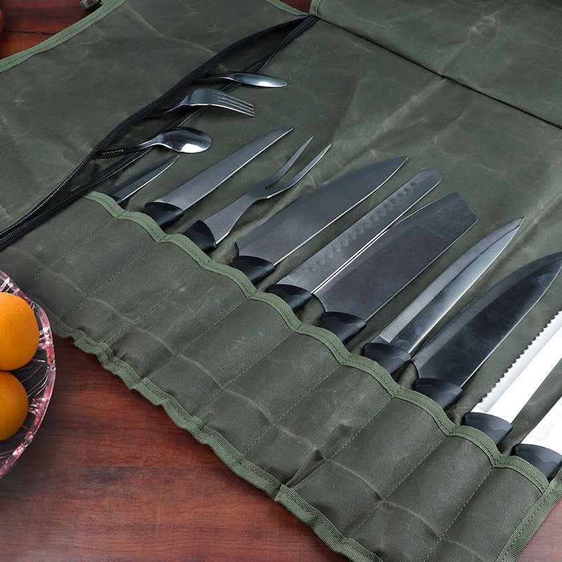 Wanderlust Canvas Knife Roll | Travel Knife Holder with knives and silverware packed away on a table with oranges to the left